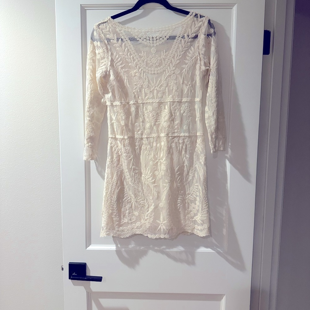 Lace lined ivory dress.  Shows a lot of leg and is extremely sexy yet flirty.